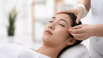 User receiving acupuncture treatment focused on eye health